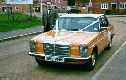 n/s/f of mercedes with ribbons and driver