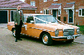 o/s/f of mercedes with ribbons and driver